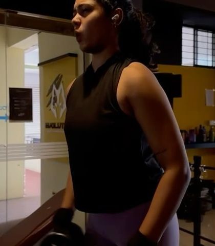 Harshitha focuses on a dumbbell exercise during her personal training session. My programs for women focus on building functional strength, which improves metabolism and overall health.