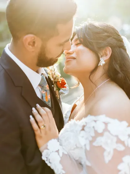 A romantic, sun-kissed close-up of the couple.