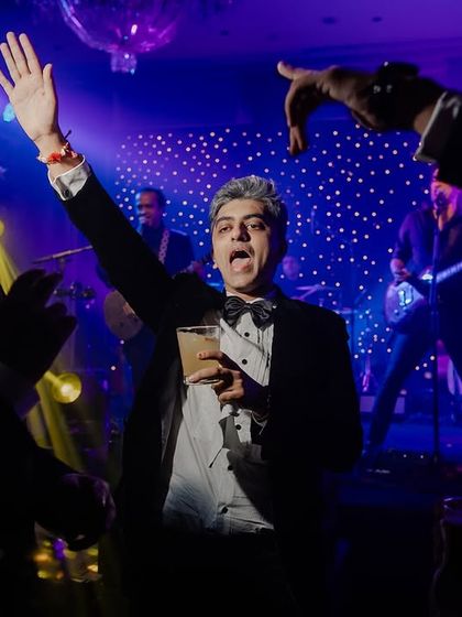 A guest having the time of his life on the dance floor. It's not just about the couple, but the joy of everyone celebrating them.