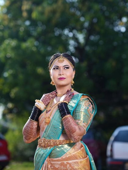 Another angle of Arpitha's muhurtham look, highlighting the traditional black bangles and intricate henna.