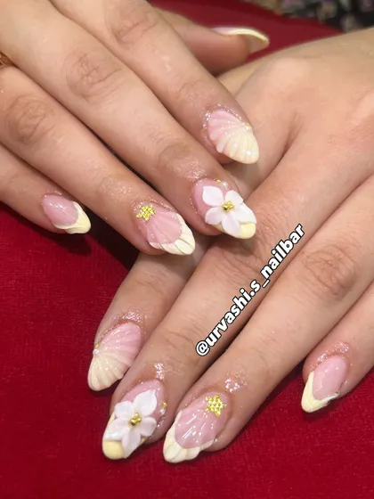 This elegant set features sculpted shell textures on the tips and hand-crafted 3D florals with tiny gold accents. The combination of textures on a soft blush base creates a truly sophisticated and artistic look.