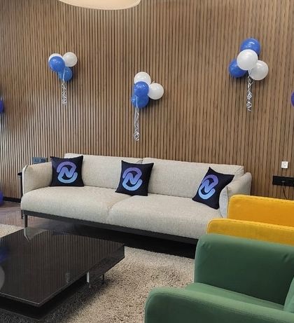 A look at our decor for a corporate office's first anniversary. We used branded pillows and custom balloon bouquets to transform their lounge area into a celebratory space.