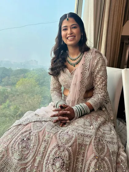 A full-length portrait of our bride, looking effortlessly elegant. The soft glam makeup ensures she is the star, with her outfit and jewellery complementing her natural glow.