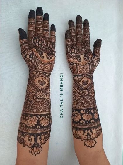 A full view of a traditional bridal mehendi with lotus and peacock designs. This style is perfect for brides who want a classic and timeless look for their wedding.