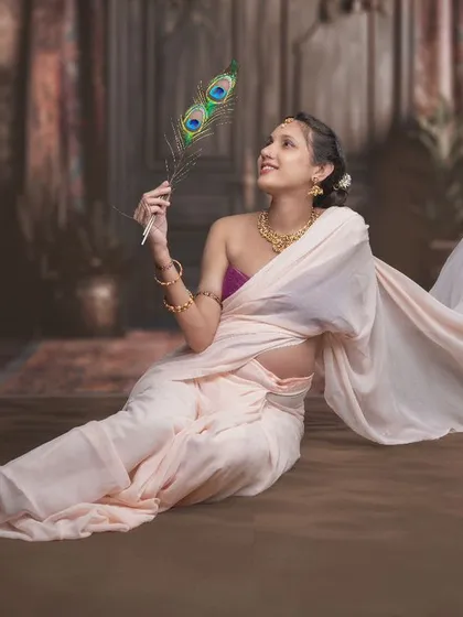 Enveloped in grace and the timeless elegance of tradition, this portrait finds a moment of serenity with a touch of the divine, celebrating both heritage and the journey of motherhood.