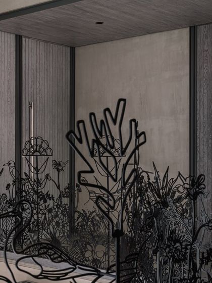 A close-up view of the 'Kalrav Seasons' railing, showing the detailed craftsmanship of the metalwork. Each element, from the swan to the coral-like branches, is carefully designed to contribute to the overall naturalistic narrative.