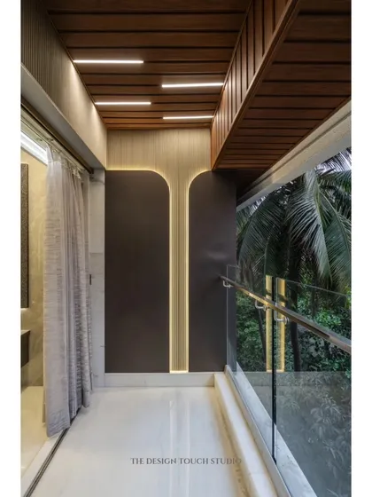 This balcony wall features a unique design with backlit curved panels, creating an artistic and sophisticated look that can be enjoyed from both inside and out.
