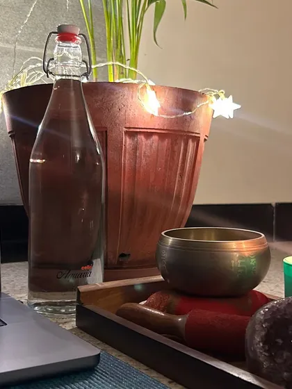 My setup for an online breathwork session, complete with a singing bowl, crystals, and a candle to create a sacred, calming atmosphere. Even from a distance, we can create a powerful space for healing.