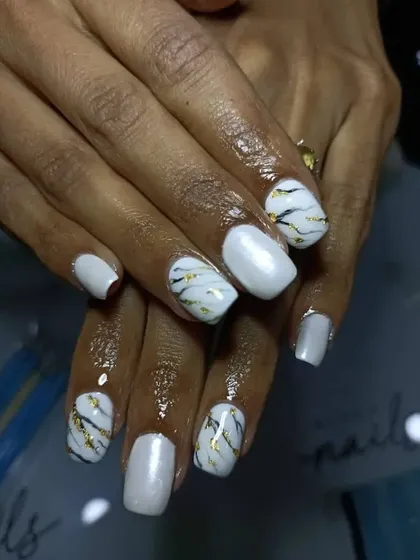 A full view of these uber classy and chic white marble nails with black and gold veining.