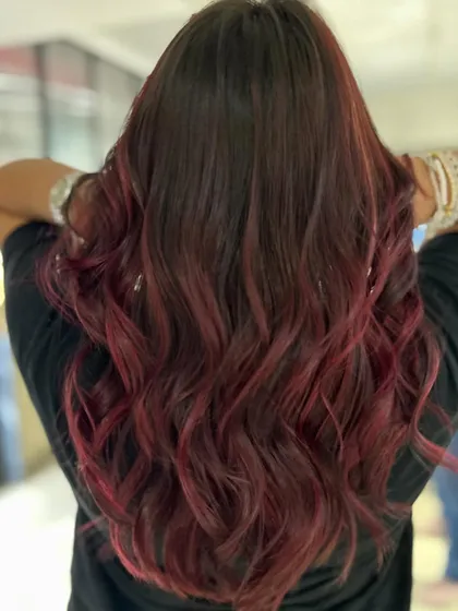 A red-hot balayage blend. This transformation to a vibrant red is bold, beautiful, and full of energy.