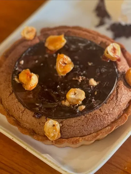 Our Dark Chocolate Soufflé Tart, topped with toasted hazelnuts. A deep, intense chocolate experience.