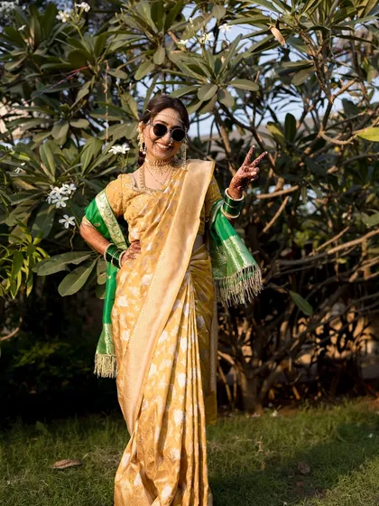 A fun, modern twist on a traditional look. The bride rocks sunglasses with her yellow Nauvari saree.