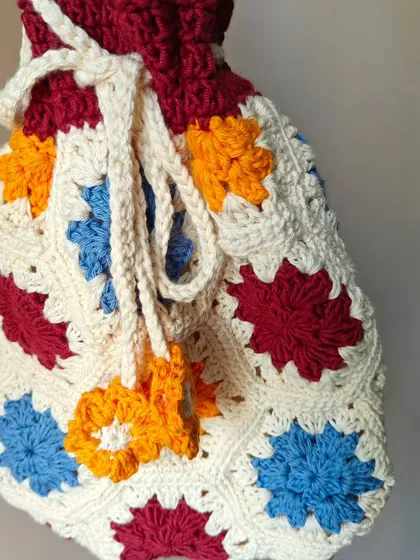 The side view of the potli bag, highlighting its spacious design. It's lightweight but can hold all your essentials.