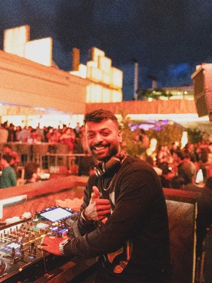 That happy moment when the beat drops and the whole crowd feels it. A great shot from a sundowner set at Pangeo, with the city lights in the background.