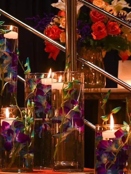 Floating candles and submerged orchids in tall glass vases lined the stairs. This is a simple yet elegant way I add touches of light and beauty to transitional spaces.