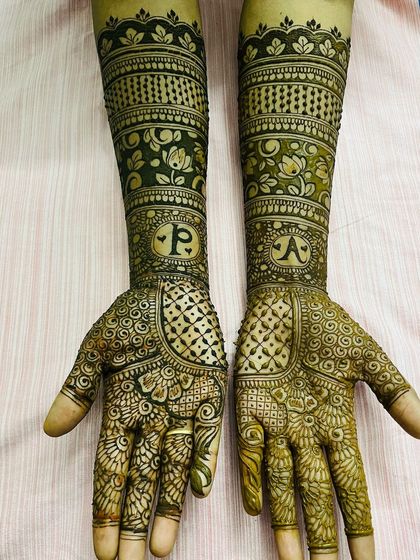 Simple and sweet personalization. Each arm features the first initial of the bride and groom, 'P' and 'A', within the floral and geometric patterns.