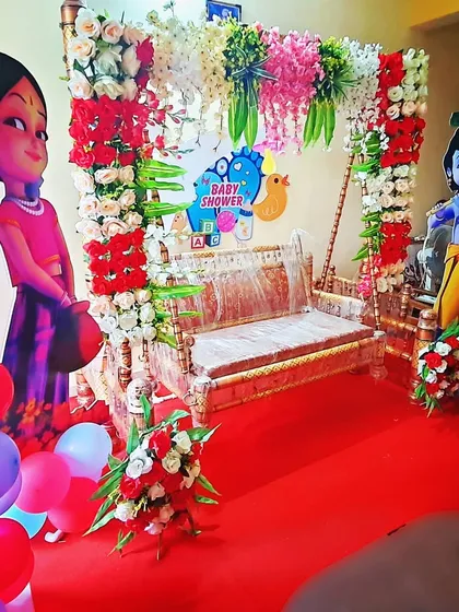 This is a compact yet vibrant baby shower decoration perfect for home functions. It includes the essential decorated jhula, character cutouts, and hanging floral arrangements to create a festive corner in your house.