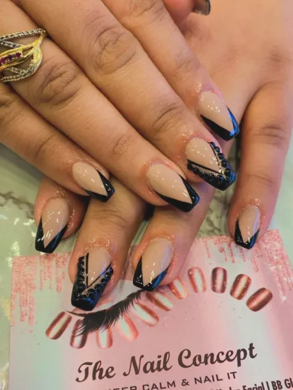 Edgy and glamorous, these coffin-shaped nails have a nude base with black V-tips. One accent nail on each hand features intricate black beadwork for added texture and detail.