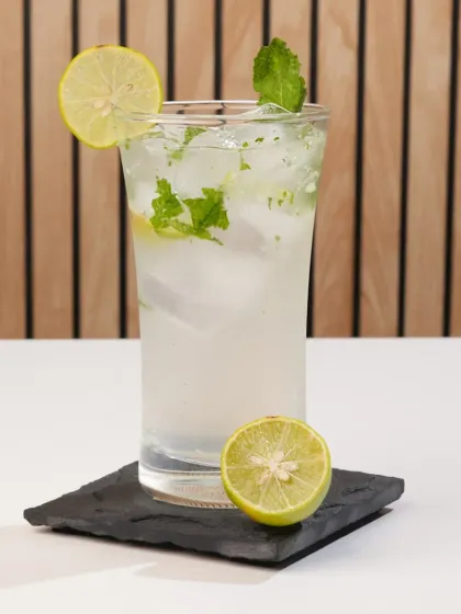 This mojito is shot in a bright, high-key style. This clean and refreshing look is perfect for a daytime cafe menu or a summer promotion.