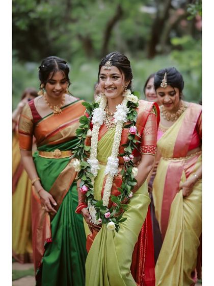 The beautiful bride walking with her bridesmaids, all in stunning silk sarees.