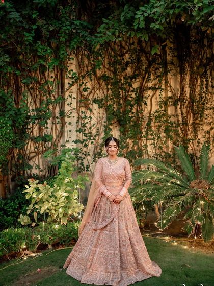 A full-length portrait of my bride Anu in her gorgeous pastel lehenga, looking like she stepped right off a Pinterest board.