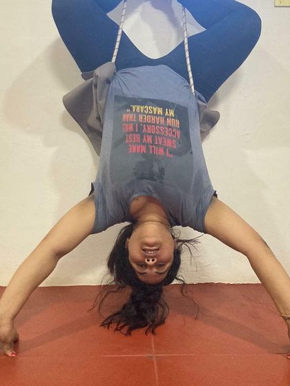 Using props like wall ropes is a key part of my teaching method for advanced poses. Here you can see my students in an inverted Baddha Konasana (Bound Angle Pose), using the ropes to decompress the spine and open the hips safely.