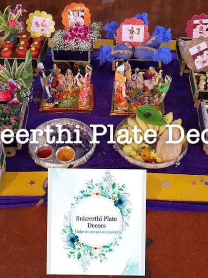 A colorful and traditional platter arrangement for an ear-piercing ceremony. The setup includes deities, decorated fruits, sweets, and other auspicious items.