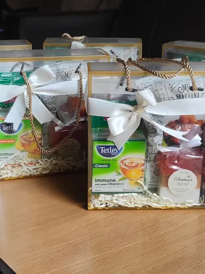 A simple 'thank you' can be made memorable. This curated hamper includes green tea, instant coffee, healthy snacks, and my own handmade honey oat milk soap, presented in a clear gift bag for a professional touch.