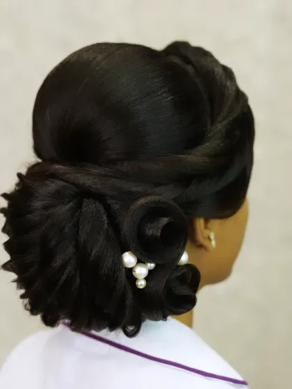A more intricate version of the side bun, with sculpted curls and pearl accents.