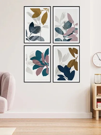 A set of four framed prints featuring abstract botanical leaves in a cool color palette. This gallery set is perfect for creating a large, impactful art installation in your living room or bedroom.