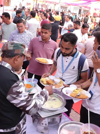 The sight of happy guests enjoying our food is our greatest reward. This photo captures the energy of a busy event, with our staff efficiently serving a large crowd from a well-stocked buffet line.