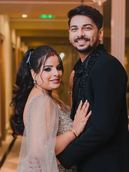 A stylish portrait of the couple at their reception, showcasing their elegant evening attire and their confident presence as a newly married pair.
