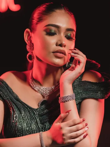 The play of light and shadow in this shot highlights the expert contouring and the shimmer of the eye makeup.