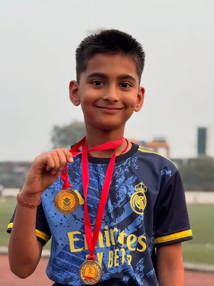 Parth holding up his two gold medals. It's moments like these that make all the early mornings and tough drills worthwhile.