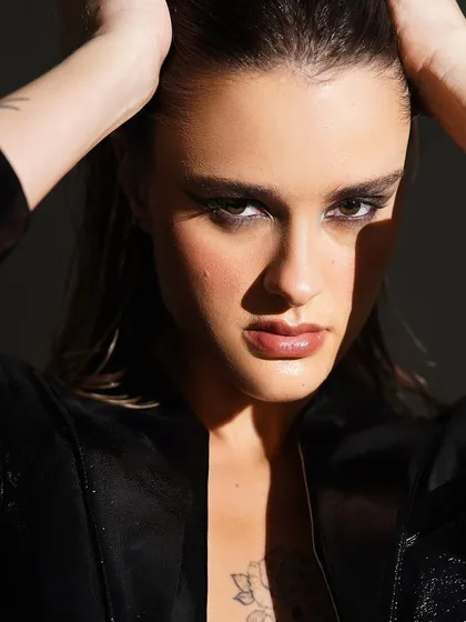Another powerful shot of the smokey eye, this time with a direct, confident gaze. The wet-look hair adds to the edgy, high-fashion feel.