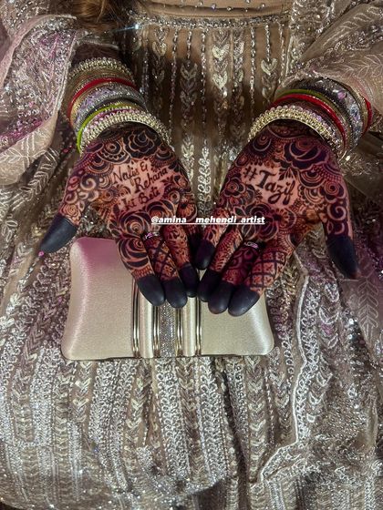 The bride's hands, adorned with intricate mehendi, colorful bangles, and holding a clutch. This is the complete party look.