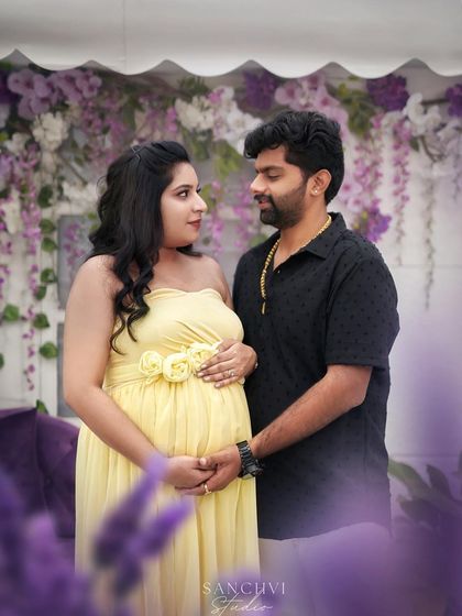 A loving gaze between partners. Our yellow floral gown and the lavender field setup create a soft and romantic atmosphere.