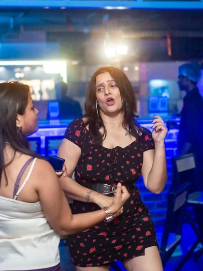 A candid shot of two women enjoying the party. The energy is palpable.