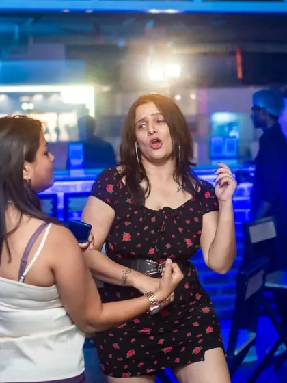 A candid shot of two women enjoying the party. The energy is palpable.