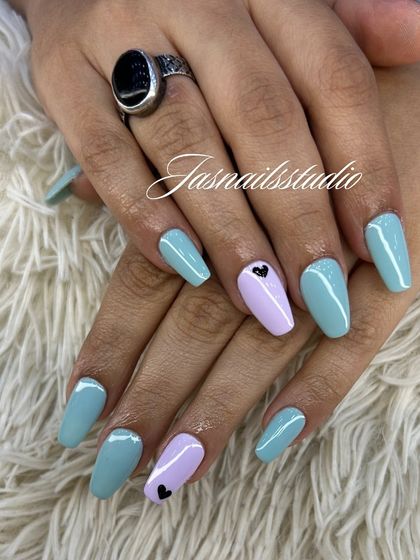 A sweet and simple pastel manicure. The mix of light blue and lilac with a tiny black heart accent is so cute and perfect for summer.