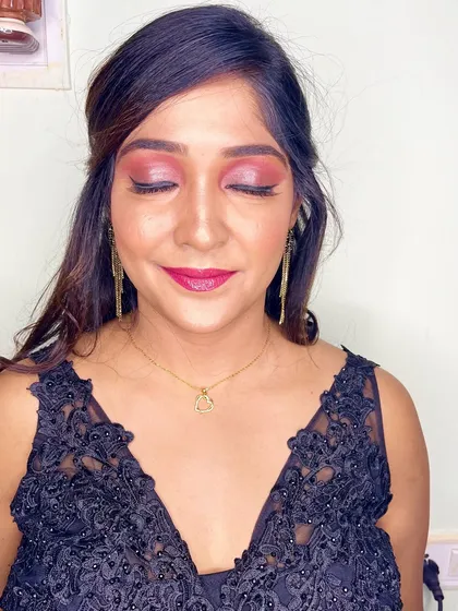 A glam party look for my client in a black gown. I created a bold pink smokey eye and a matching bright lip.