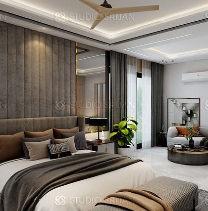 The bed in the DLF room is set against a plush, grey, channel-tufted headboard wall, with elegant mirrored panels on either side.