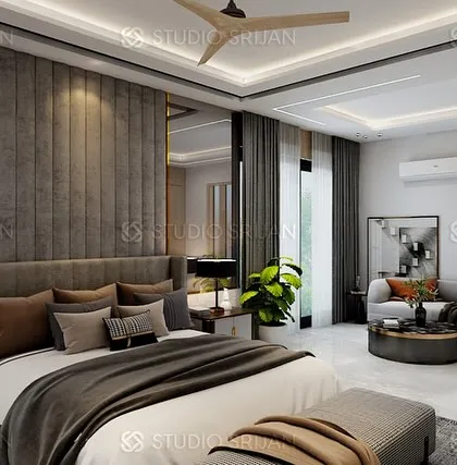 The bed in the DLF room is set against a plush, grey, channel-tufted headboard wall, with elegant mirrored panels on either side.