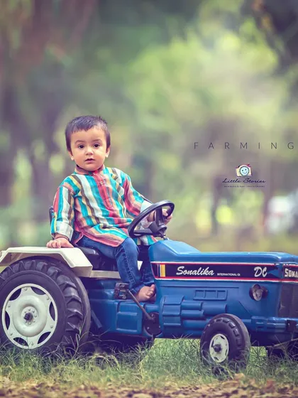 From the farm to the photo. This themed shoot with a toy tractor brings a touch of rustic charm and allows for imaginative play during the session.