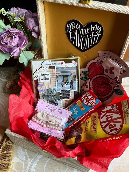 This birthday gift hamper is perfect for your squad. It includes a vintage-style glass frame, a face mask for a little pampering, and plenty of chocolate, all packed in a reusable trunk.