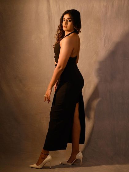 Another angle from the shoot, showcasing the elegant silhouette of the dress and the soft, glamorous hair.