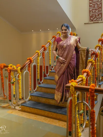 A beautiful full-length portrait of the bride on the staircase of her home, just before the ceremony begins.