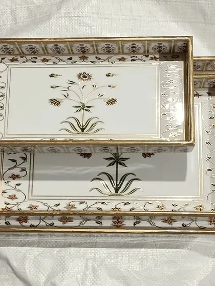 Exquisite serving trays with intricate floral designs, another example of the unique home decor items available.
