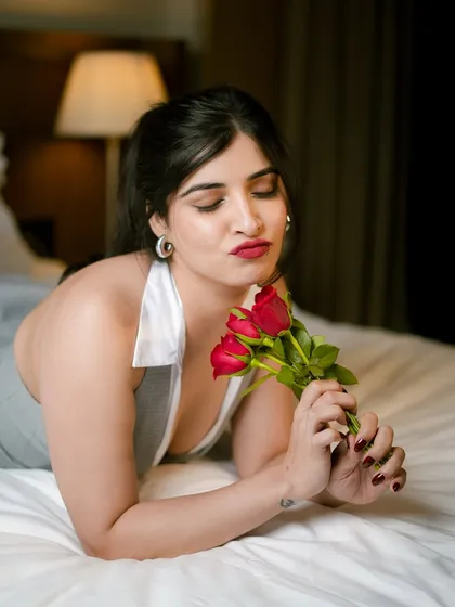 A soft and romantic close-up of Parul Mundra. This angle shows the flawless application of the red lipstick and the subtle shimmer on the eyelids.