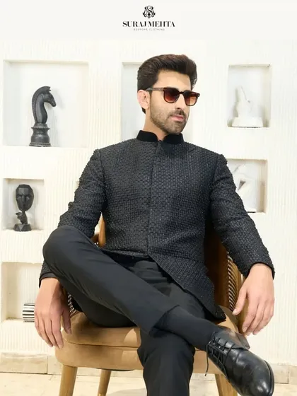 I redefine traditional attire with this sleek black Jodhpuri suit. The modern, sharp cut and textured fabric seamlessly blend heritage with contemporary flair, making it a perfect choice for a bold and stylish statement at a reception or formal gathering.